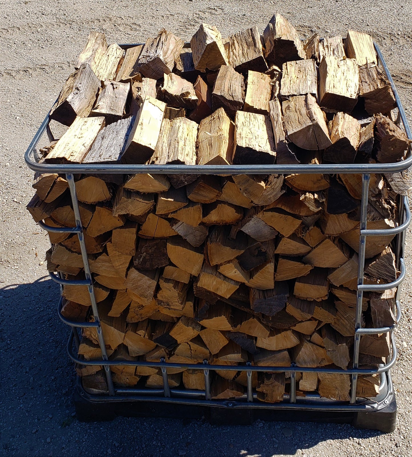 Front edge view of triple stack firewood crate outside in the sunshine